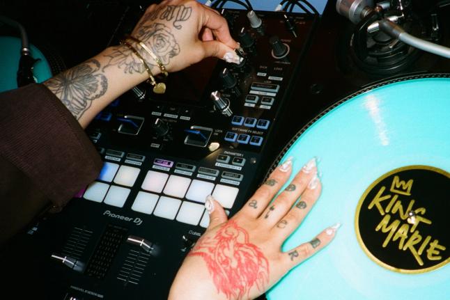 King Marie's hands on a DJ controller