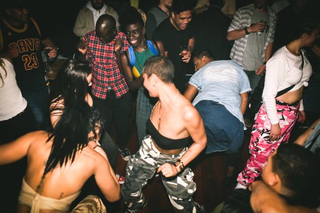 A group of people dancing in an indoor venue
